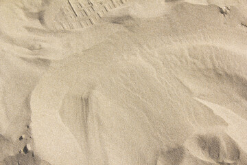 A close-up of the sand on the beach.
