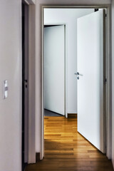 Modern apartment hallway with light wood floors and open doors in Argentina for rent. latin america