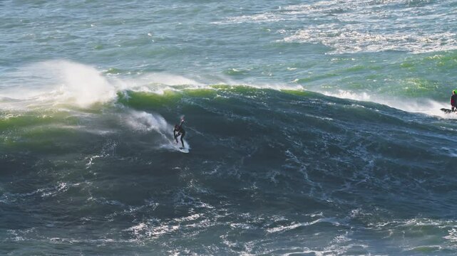 Surfer is riding big wave.Extremal big wave surfing. Nazare, Portugal
