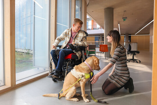 Disabled coworkers with guide dog in office