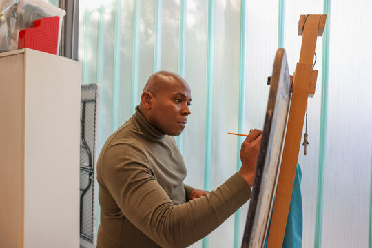 Man painting in workshop