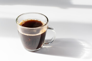 Cup of Coffee on a Table in Early Morning Light.
