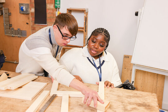 Disabled man and woman working in workshop