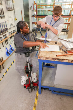 Disabled man and woman working in workshop