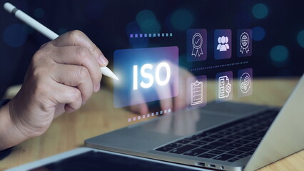ISO certification and quality management concept. Business professional reviewing ISO certification...