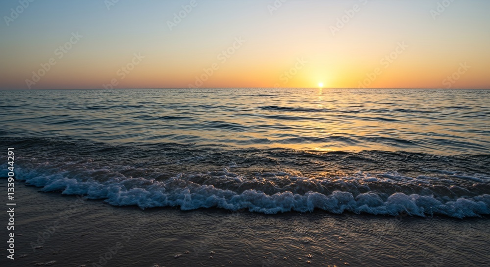 Poster the ocean is calm and the sun is setting, creating a beautiful
