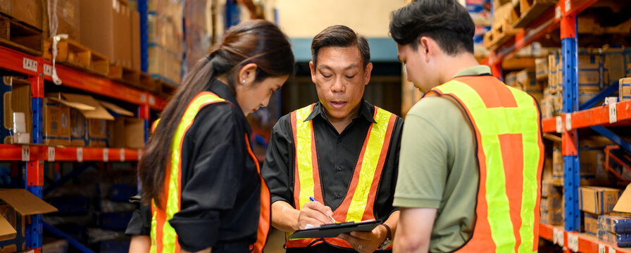 warehouse managers hold clipboard of perform inventory stock goods check list and talking with employees. group of warehouse employees.