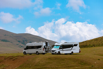 Fototapeta premium Motorhomes on the highland. Adventure concept photo