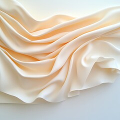 Fototapeta premium Soft beige fabric elegantly draped, showcasing gentle folds and smooth texture under diffused light.