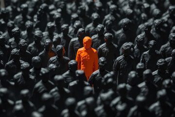 Fototapeta premium Unique Individual in Vibrant Orange Among Uniformed Figures in Dark Environment