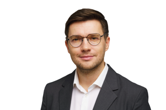 Professional man wearing glasses in formal attire posing confidently for a portrait against a white background