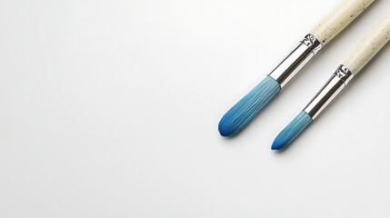 High-Quality Paint Brushes with Blue Tips on a Minimalist Background for Artistic Creations