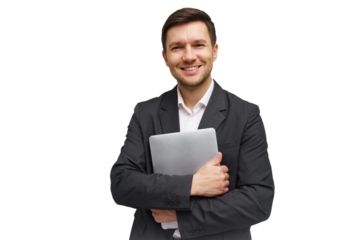 Business professional smiles while holding a laptop in a studio setting during daylight hours