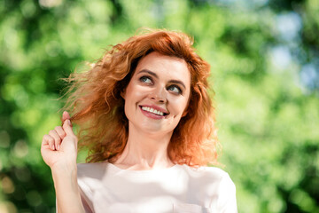 Naklejka premium Photo of nice young woman touch hair look away think wear t-shirt free time walk fresh air park outdoors