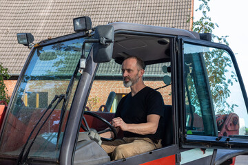Man operating a telehandler on a farm.