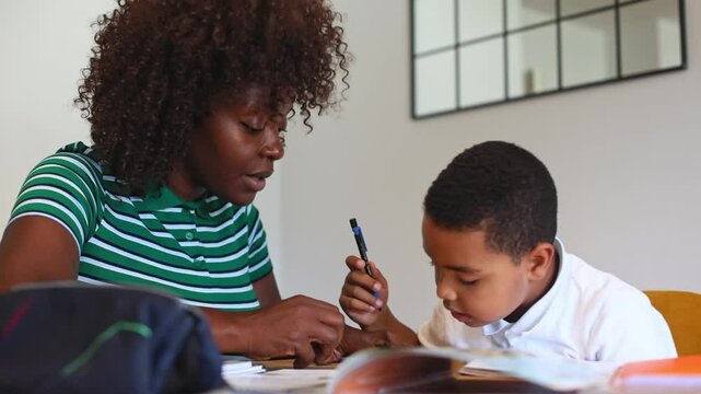 Mother helping son with homework at home