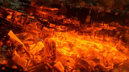 Close-up of Hot Embers with Flying Sparks . Concept of heating grills or ovens