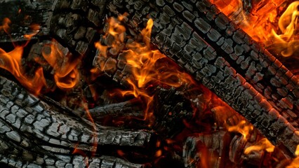 Close-up of Hot Embers with Flying Sparks . Concept of heating grills or ovens