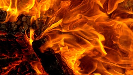 Close-up of Hot Embers with Flying Sparks . Concept of heating grills or ovens