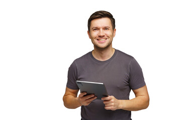 Man smiling while holding a tablet in a bright indoor setting, showcasing a friendly demeanor and...
