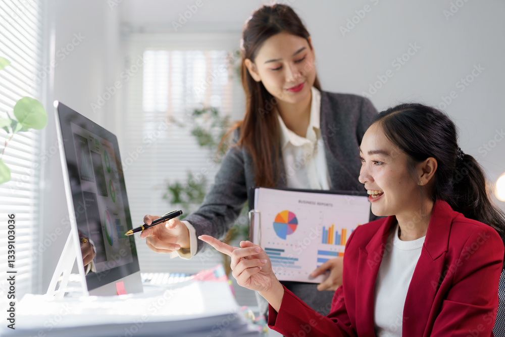 Aufkleber two businesswomen are discussing financial charts and graphs displayed on a computer screen, collabo