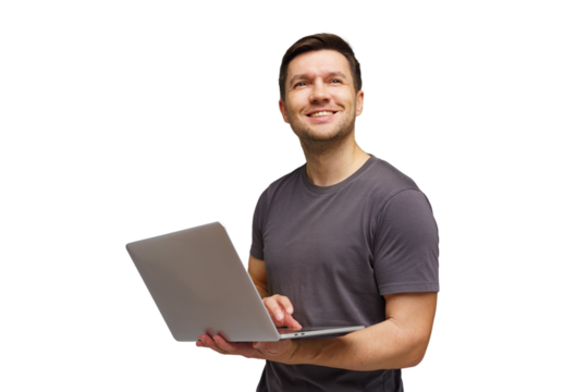 Man smiling while using a laptop, seemingly engaged in a positive activity at home