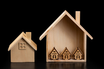 Symbolic wooden houses on black background