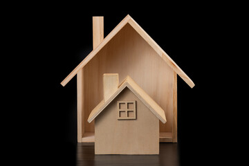 Symbolic wooden houses on black background