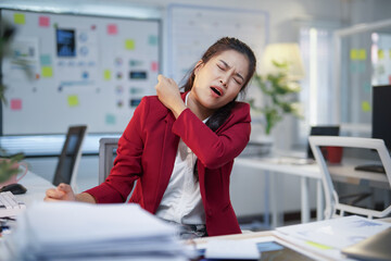 Office worker experiencing discomfort and muscle tension due to prolonged desk work and poor posture