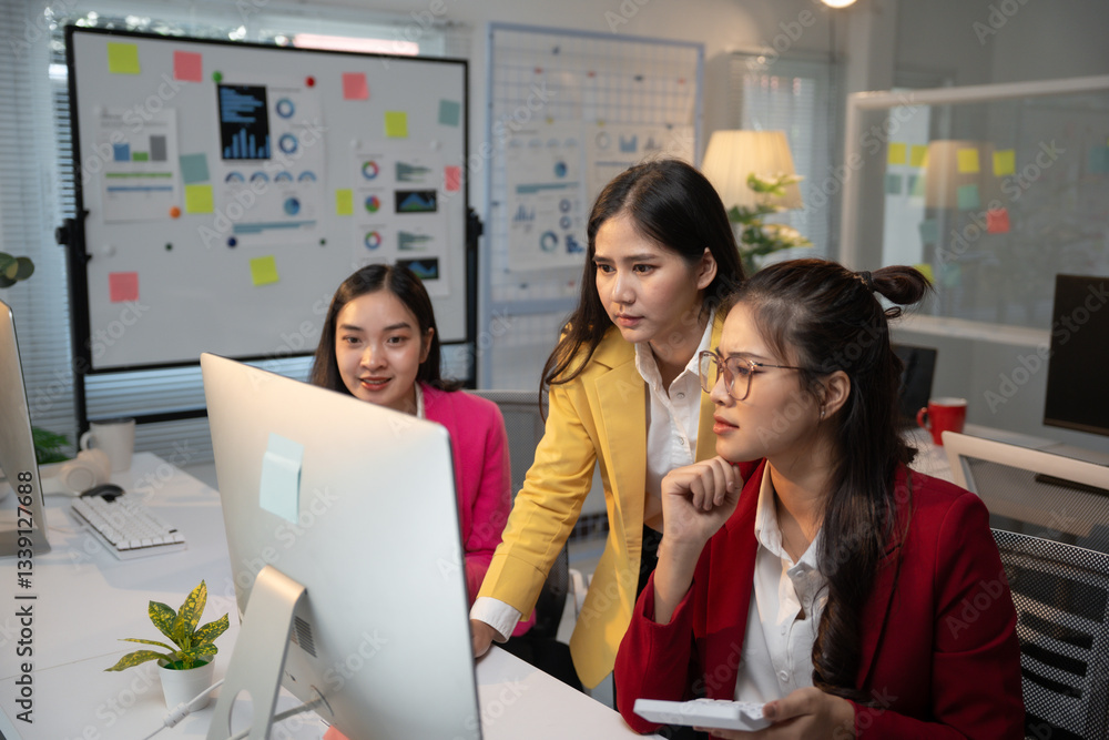 Aufkleber three asian businesswomen are collaborating on a project, analyzing data on a desktop computer in a 
