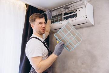 Repairman disgusted by dirty air conditioner filter