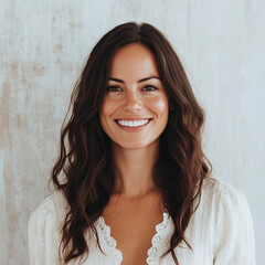 Portrait of smiling happy woman with white blouse and white background. long Brunette hair
