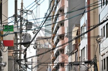 Electric pole with wires and lamp outdoor in the street