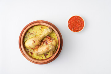 Lontong opor ayam is an Indonesian traditional dish usually served during eid Mubarak, Eid al Fitr holiday celebration with Ketupat Lebaran or rice cake dumpling and sambal chili sauce.