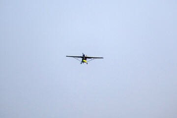 propeller plane is flying on isolated blue sky 