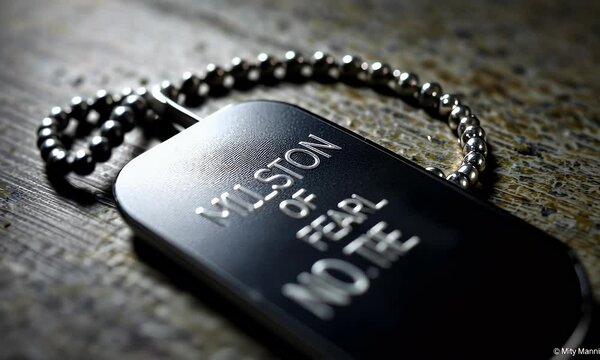 Metallic Dog Tag On Rustic Wood Close Up View Of Engraved Military Id Tag Details And Its Inscription On A Wooden Surface With Dark Lighting Effects.  Its Vintage And Somber Feel Emphasizes The