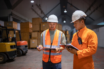 Two parcel inspectors work together to inspect parcels in a large warehouse.