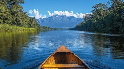 Canoeing a serene lake towards majestic mountains