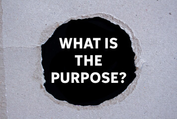 What is the purpose message written on ripped torn paper on black background. Conceptual what is...