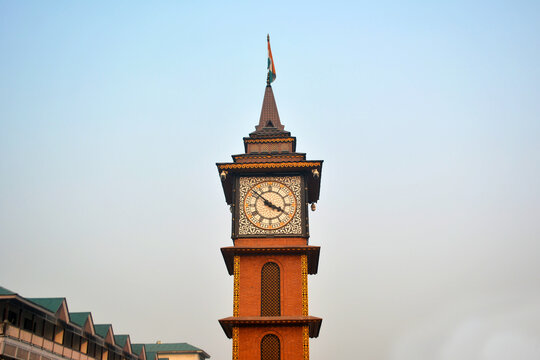 Clock tower with Indian flag at Lal Chowk, Srinagar. Architectural landmark, urban photography, cultural symbol. Clear sky, historic building, capturing the iconic clock tower and its significance