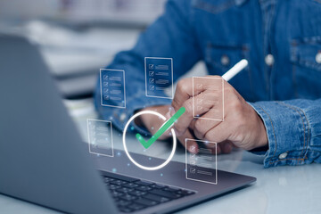 Quality Assurance and quality control Concept,Businessman Working at Desk Using Pen Touching on Certification Approval Standard or Document Management Icon Showing Quality Check with Virtual Screen