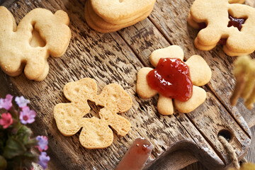 Filling Linzer Easter cookies with strawberry marmalade
