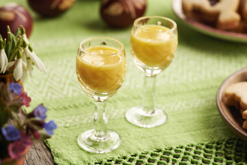 Two shot glasses of Eiecognac with spring flowers