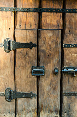 Rustic Wooden Door with Metal Hinges and Weathered Texture