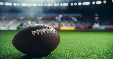 Close Up Shot of an American Football on a Green Field, Illuminated by Stadium Lights with Cheering...