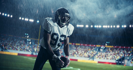 Portrait of an Athletic African Footballer Throwing a Pass to His Teammate. American Football...