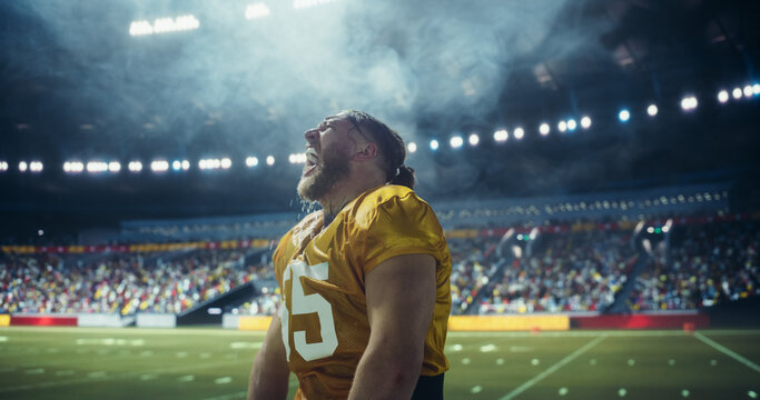 Male Athlete in Uniform Hydrates on Field, Expressing Intensity and Determination During Timeout. American Football Player Drinking Water During Championship Game. Healthcare and Sportsmanship Concept - Powered by Adobe