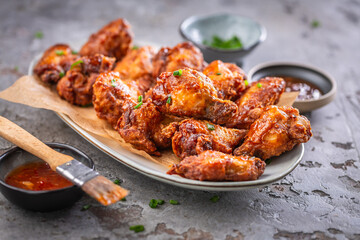 Spicy thai chicken wings with hot dip and green onions