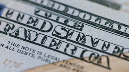 This is a macro shot that vividly showcases the intricate features of a hundred dollar bill