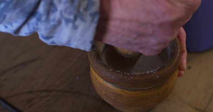 crushing food into powder in small bowl